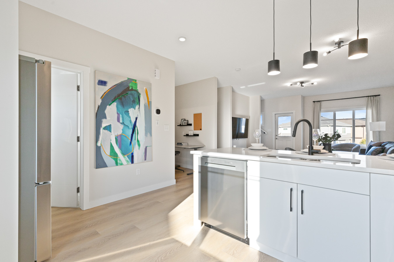 Open-concept kitchen with island and adjacent living area