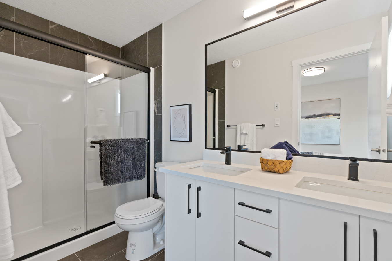 Primary ensuite with double vanity and glass shower